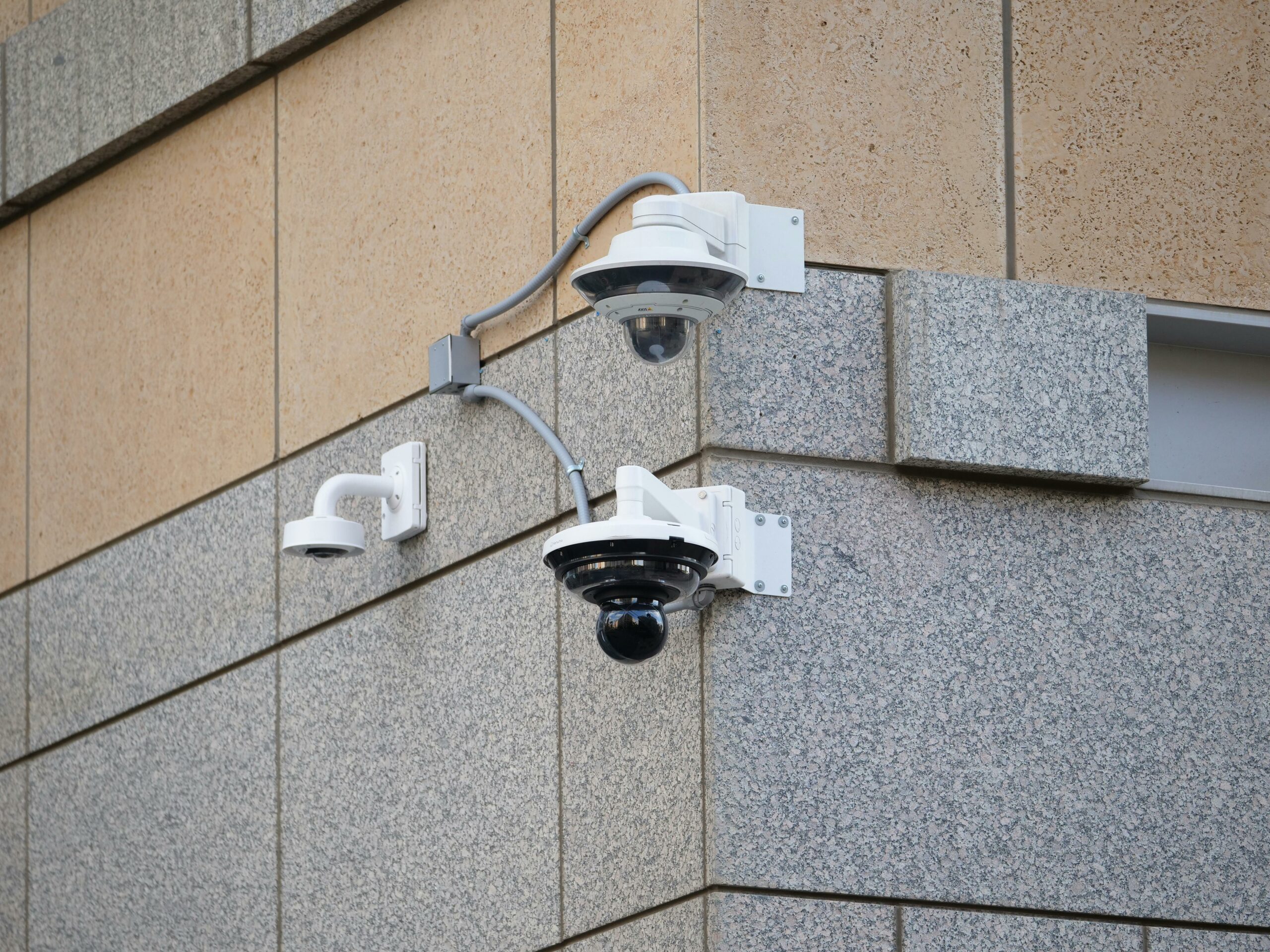Security cameras mounted on a building wall providing surveillance and safety.